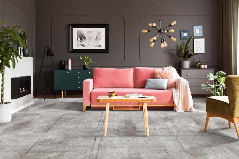 expressive grey carpet in living room with pink velvet couch
